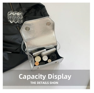 Internal view of silver metallic bow square bag showing capacity for phone and cosmetics
