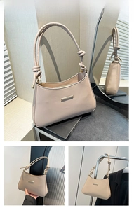Detail view of khaki hobo shoulder bag with knotted strap and gold hardware accents