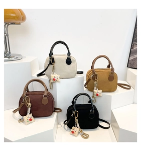 Four vintage bowling bags in cream, camel, coffee, and black with cute plush charms