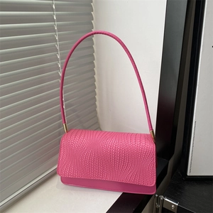 Pink woven texture shoulder bag with golden metal hardware and sleek top handle