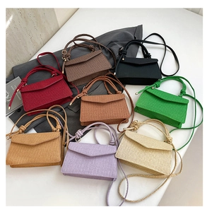 Detailed pile of woven crossbody bags in seven vibrant colors for spring and summer