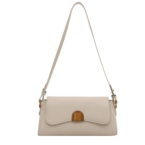 Minimalist beige leather shoulder bag with vintage bronze metal buckle on white background
