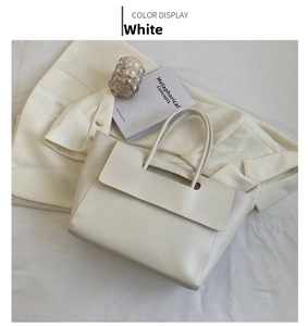 Flat lay of a minimalist white large-capacity tote bag with sleek PU leather handles