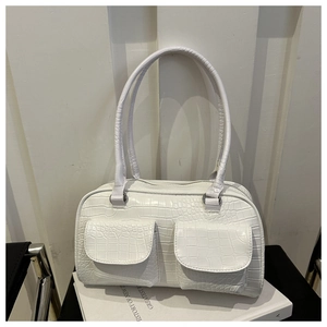 Detail view of white crocodile pattern shoulder bag with two front flap pockets