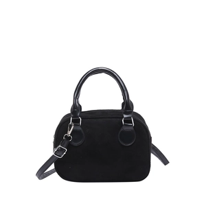 Minimalist black suede pillow handbag with silver hardware and adjustable shoulder strap