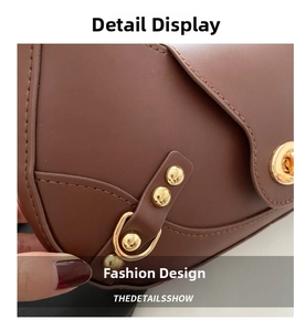 Detailed macro view of high-quality brown leather texture and gold buckle of the shoulder bag