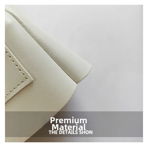 Close-up of premium cream faux leather with fine lychee grain and neat stitching details