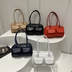 Minimalist faux crocodile leather tote bags in five colors on a tiered display