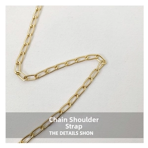 Polished gold metal chain strap detail with classic interlocking oval links for handbag