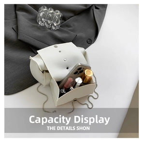 Internal view of a white leather mini flap bag showing capacity for phone and lipstick