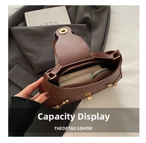 Interior view of brown crescent shoulder bag showing spacious capacity and compartments
