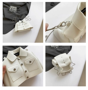 Macro shot of white jacket-shaped crossbody bag with silver chain and button details