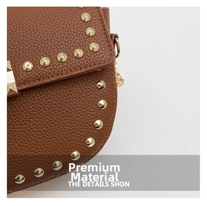 Detail of brown litchi pattern leather bag with golden rivet studs and metal chain