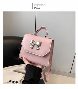 Pink bow square handbag detail with silver metal bow accent and smooth PU leather