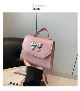 Pink bow square handbag detail with silver metal bow accent and smooth PU leather