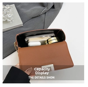 Detailed interior view of the brown lychee leather bag showing its spacious capacity