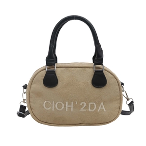 Retro khaki suede bowling handbag with black leather straps and white embroidery