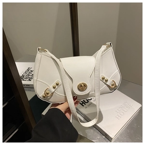 Detail of white faux leather underarm bag with gold turn-lock and metallic rivets