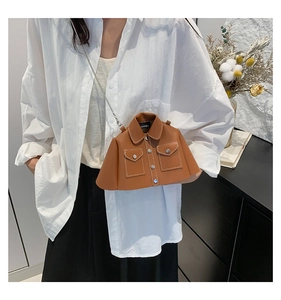 Detailed view of the unique brown shirt-shaped leather crossbody bag with chain strap