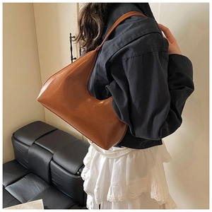 Close-up of brown leather hobo crescent bag with Fashion & Bag embossed detail
