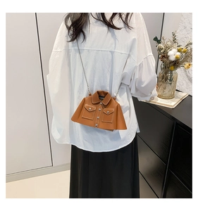 Detail of creative jacket-shaped brown leather crossbody bag with silver metal chain strap