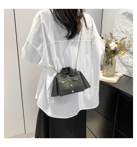 Detail of creative biker jacket style shoulder bag featuring silver chain and PU leather