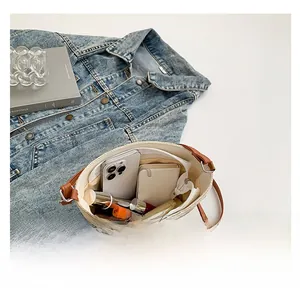 Macro view of woven shoulder bag interior showing large capacity and zipper closure