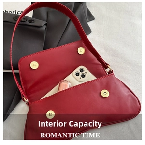 Internal capacity of the red leather shoulder bag showing space for phone and lipstick