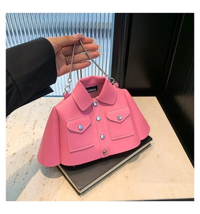 Close-up of pink jacket-shaped handbag featuring collar, buttons and metal chain strap