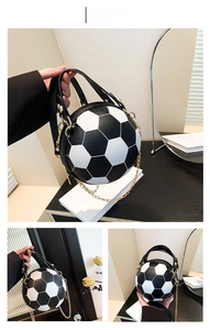 Detail of creative football-shaped handbag with black and white panels and gold chain strap