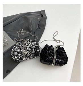 Detail of sequined bucket bags with metallic chain and pearl drawstring accents