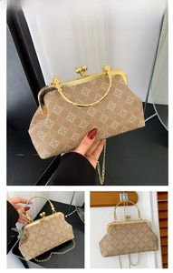 Detail of khaki shell bag featuring quatrefoil pattern texture and gold metal chain strap