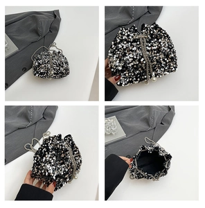 Detail of silver sequined bucket bag with pearl drawstring and metal chain strap
