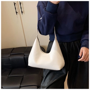 Detailed view of the white leather hobo bag with zip closure and minimalist brand logo
