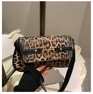 Close-up of leopard print shoulder bag with iconic gold horsebit buckle detail