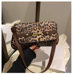 Close-up of leopard print shoulder bag featuring a vintage golden horsebit buckle detail