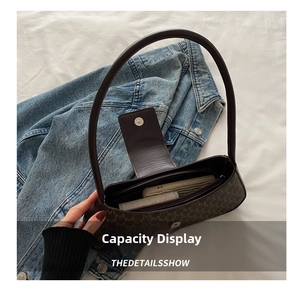 Interior capacity display of dark brown monogram baguette bag showing daily essentials