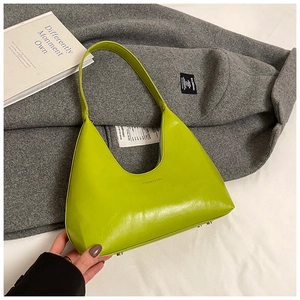 Detail of lime green leather underarm bag with embossed logo on grey cashmere coat