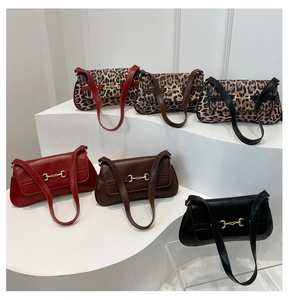 Close-up of retro baguette bags with gold horsebit hardware in leopard and solid colors