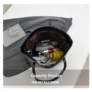 Internal storage view of black lychee grain tote bag holding tablet and daily items