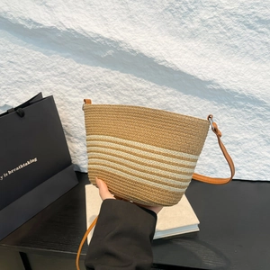 French style straw bucket bag with white stripes and adjustable brown leather strap