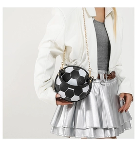 Detail of soccer ball shaped crossbody bag featuring black and white faux leather panels