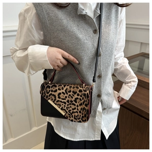 Detailed leopard print patchwork crossbody bag with gold metal accents and top handle