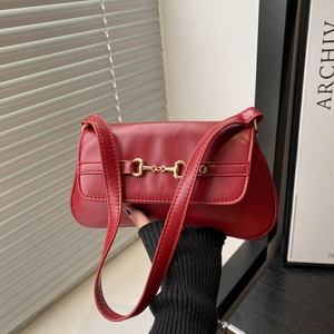 Retro deep red rectangular shoulder bag with golden horsebit hardware in elegant interior