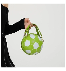 Detail view of a creative soccer-shaped handbag in green and white PU leather