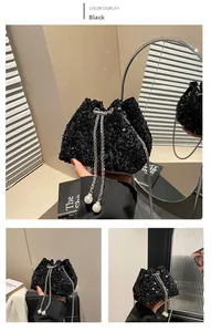 Close-up of black sequin bucket bag with silver chain strap and pearl drawstring detail