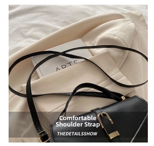 Detail of adjustable black leather strap with premium gold metal buckle and hardware