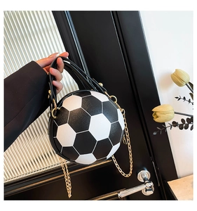 Detail of soccer ball shaped crossbody bag featuring PU leather and gold chain strap