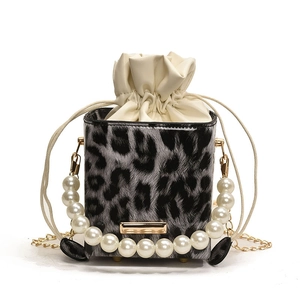Chic leopard print bucket bag with pearl handle and golden chain shoulder strap
