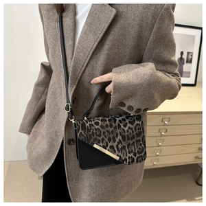 Chic leopard print crossbody bag with gold buckle details and adjustable strap for women